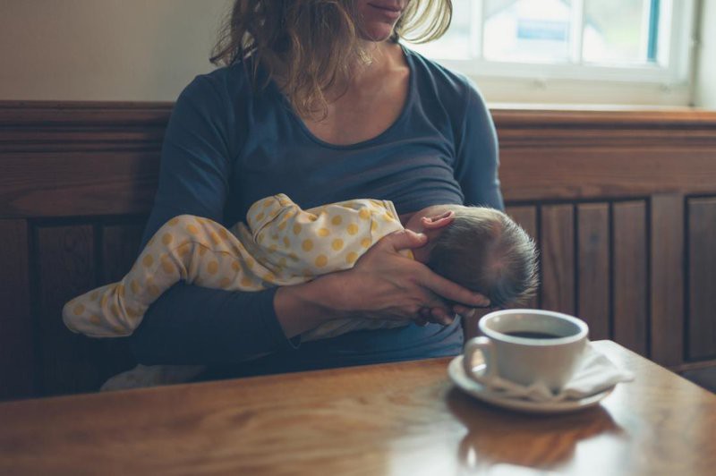 b2ap3 large rsz woman breast feeding in front of coffee mug in cafe