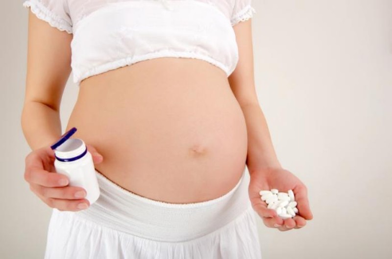 b2ap3 large pregnant woman holding medication