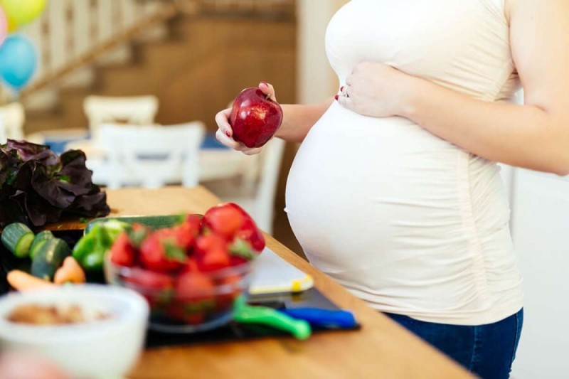 b2ap3 large Pregnant Woman Holding Apple