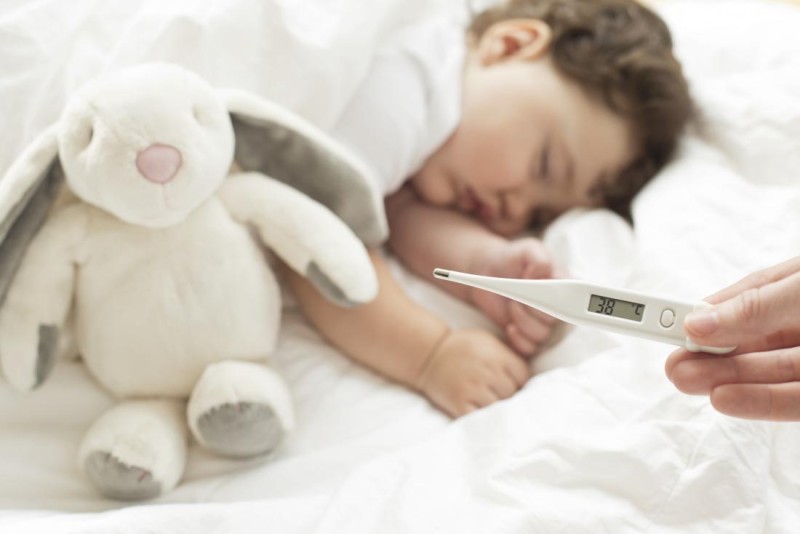 b2ap3 large toddler asleep with a temperature monitor in foreground showing fever